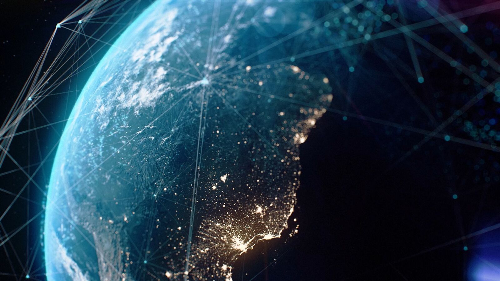 The Earth at night seen from space, with lines of light linking cities