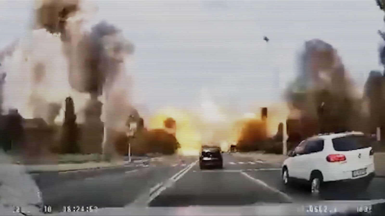 Explosions on a city road filmed from a car