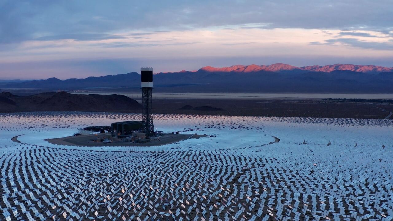 A solar power plant in a desert at dusk