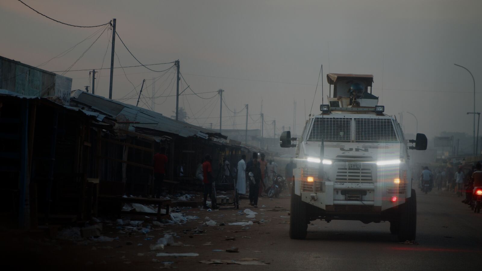 An armoured peacekeeping vehicle on a road at dusk