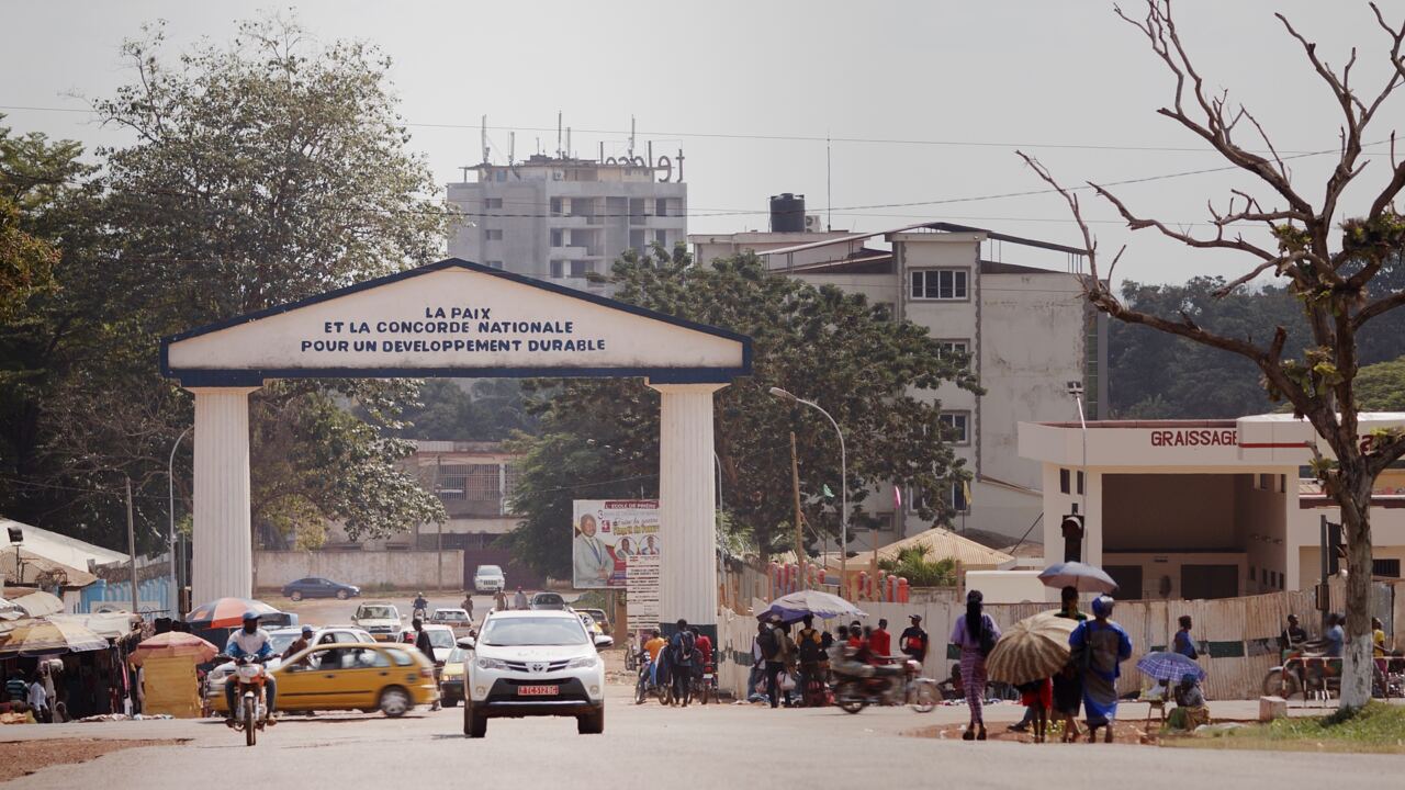 A monument arch over a busy city street