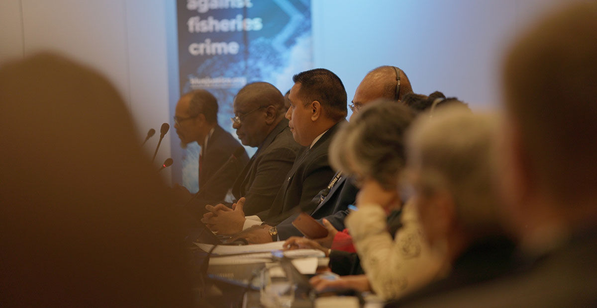 Delegates seated around the conference table