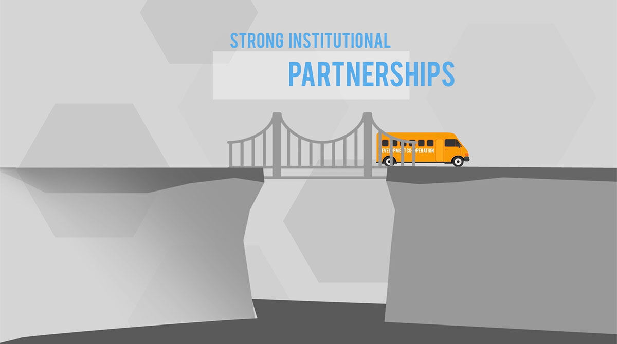 Animation still: a development co-operation bus crossing a bridge of strong institutional partnerships