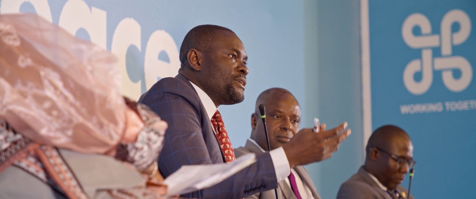 A panellist speaking in front of the Global Peace backdrop