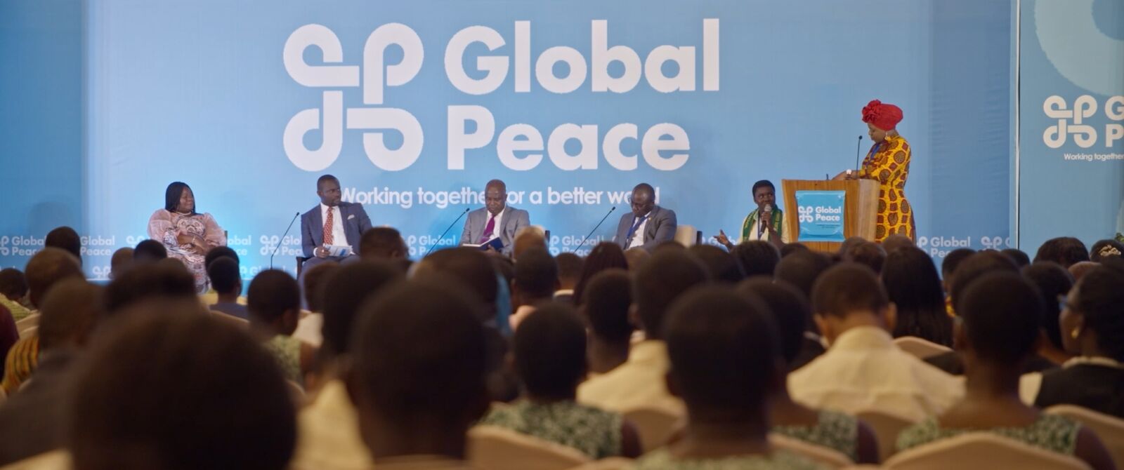 A Global Peace dialogue, with young people in the audience and the Global Peace identity on stage