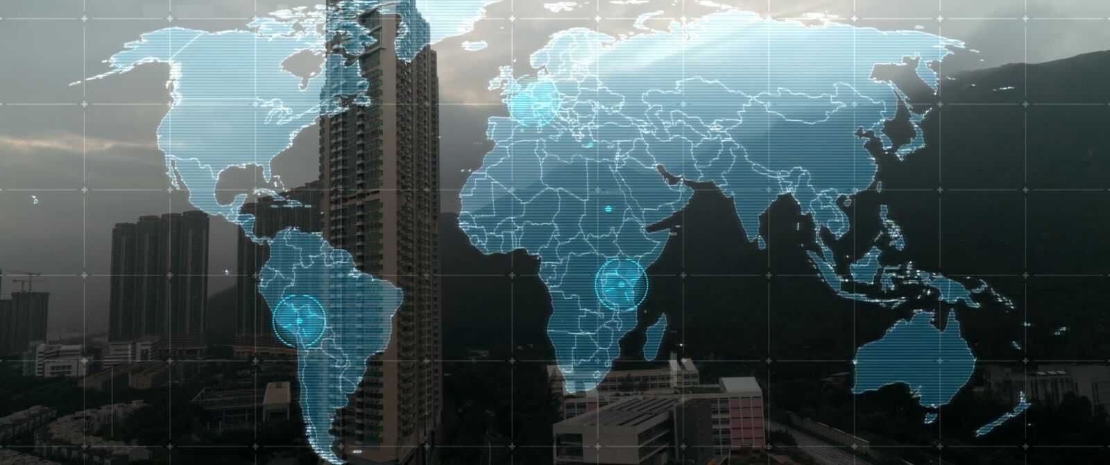 Film still: a digital world map over a city skyline