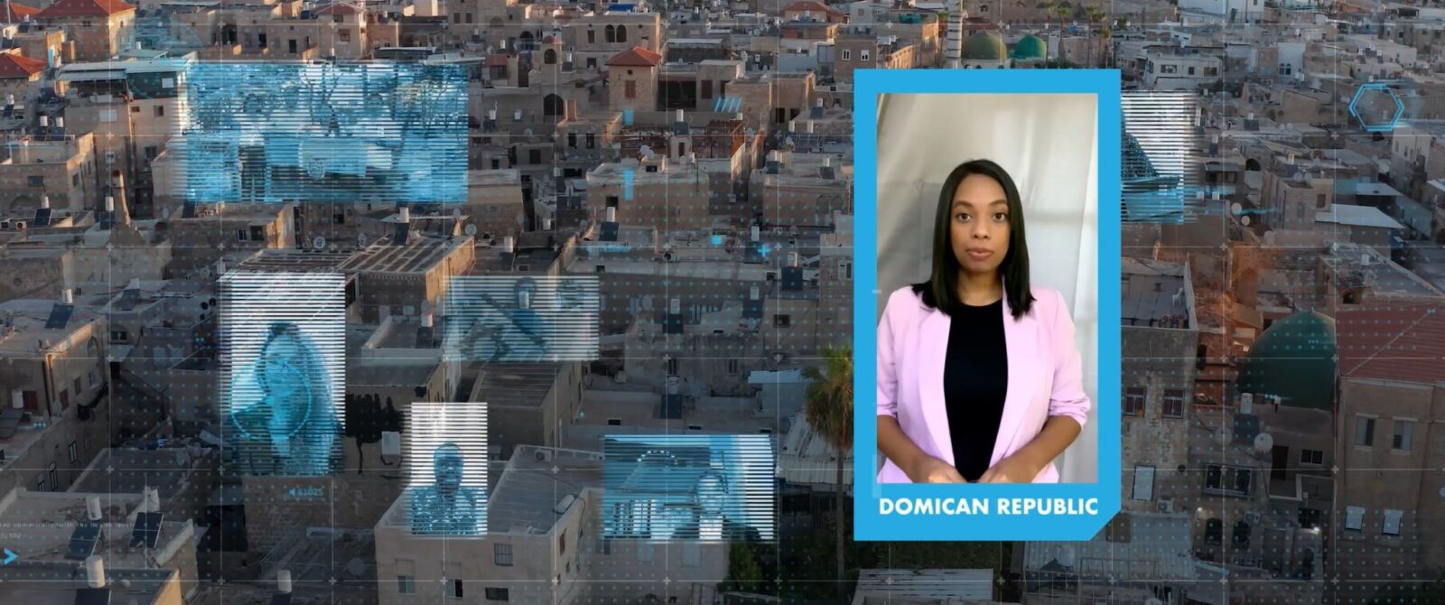 Film still: a young speaker from the Dominican Republic over a city