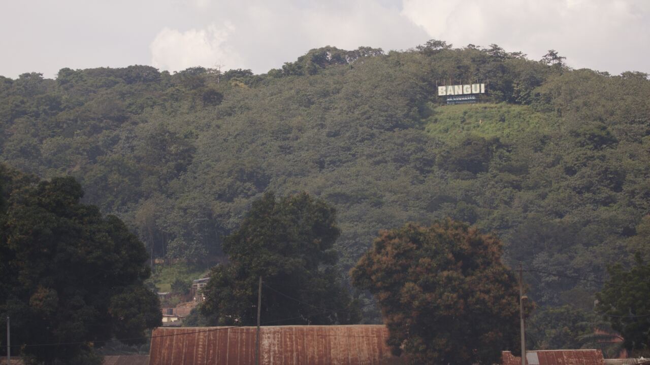 The Bangui sign on a forested hill above the city