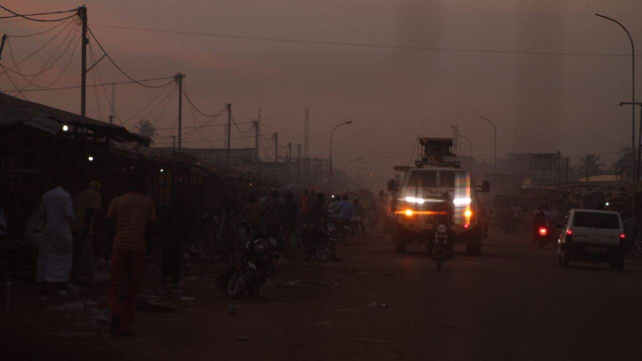 A UN armoured vehicle on a Bangui street at dusk