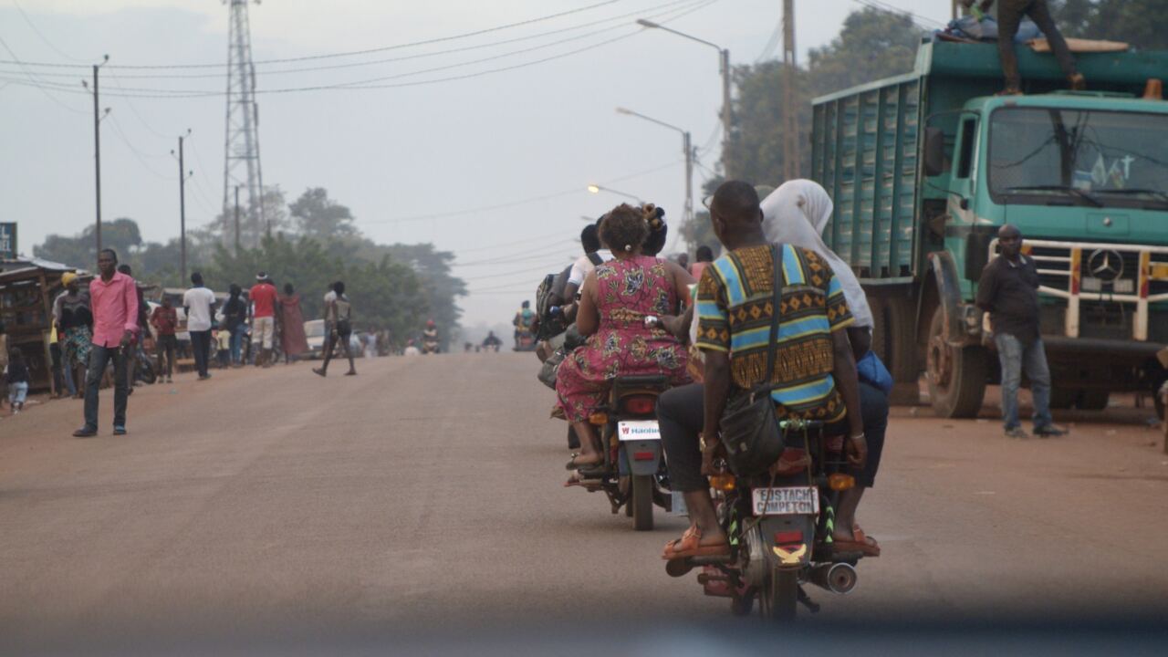 Motorcycles and trucks on a busy road