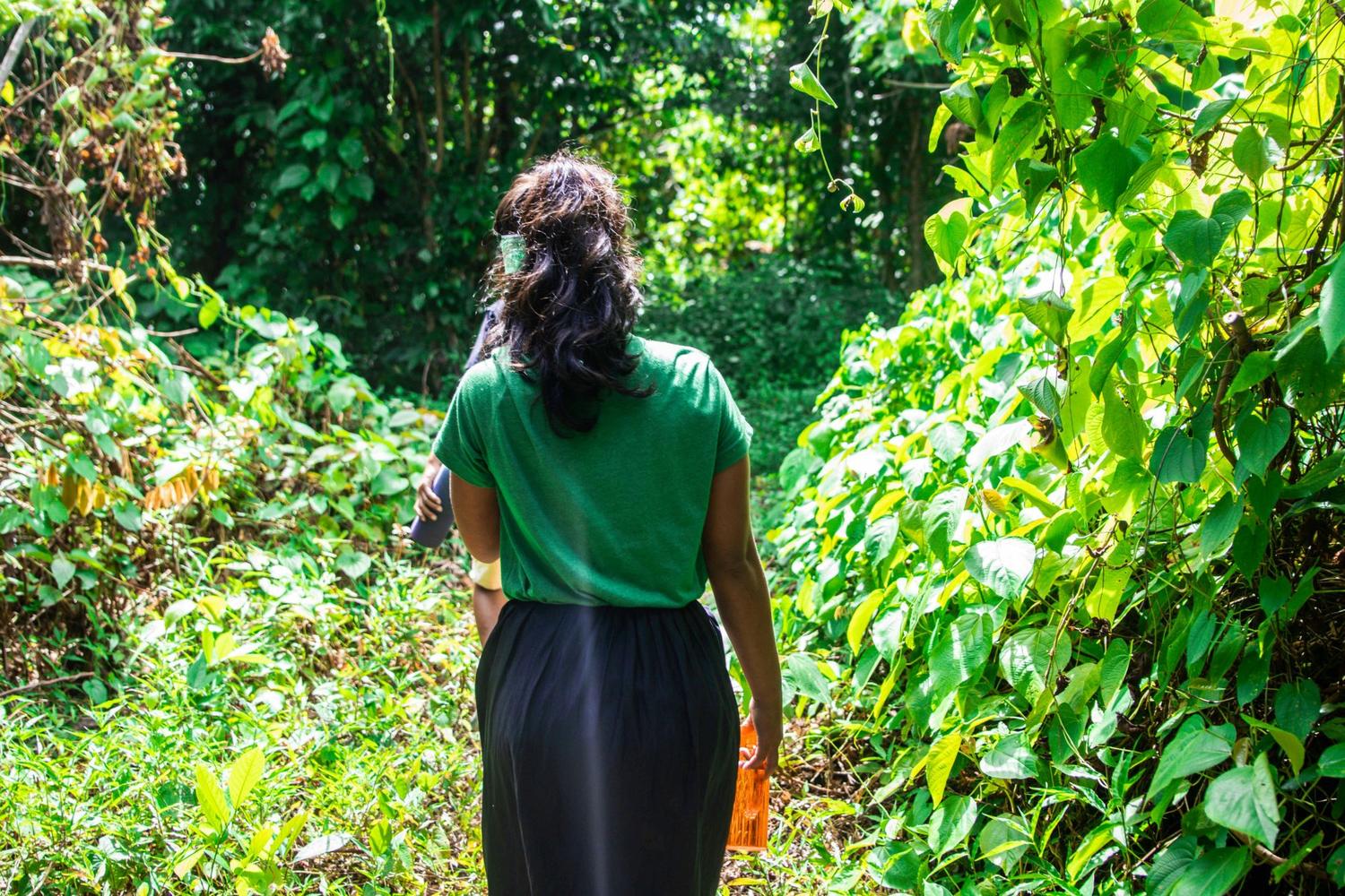 A woman walking along a forest path
