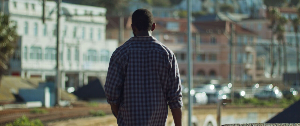 The man walking through town with the fish