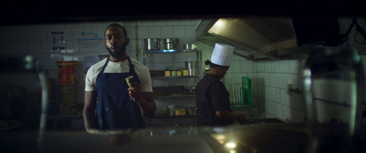 The man in an apron in a restaurant kitchen