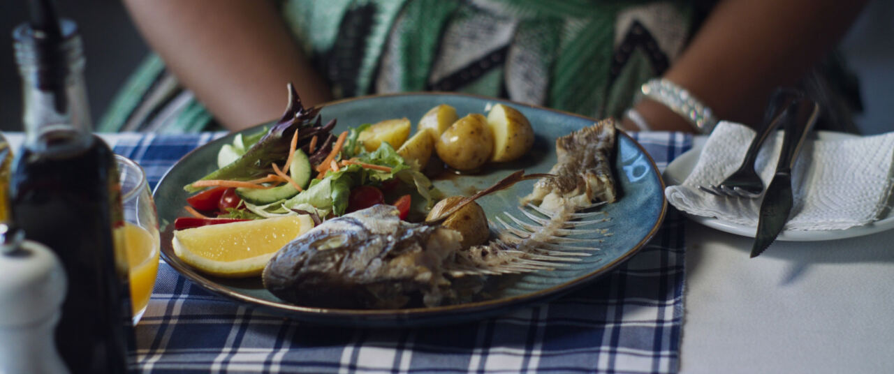 A plate with only the bones of a fish left on it